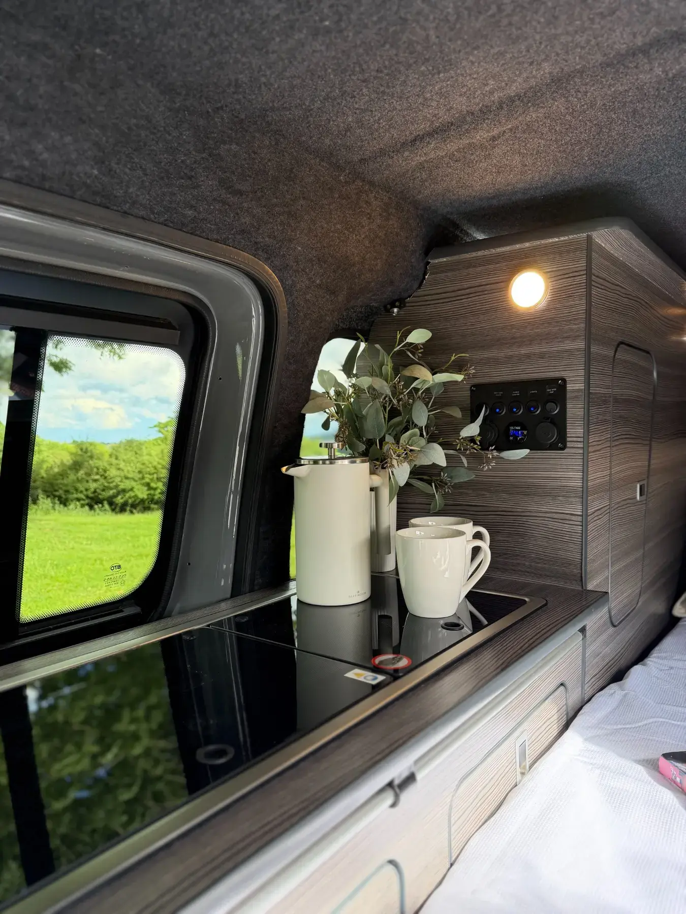 Genuine completed camper kitchen with gloss worktop, fitted storage and power controls