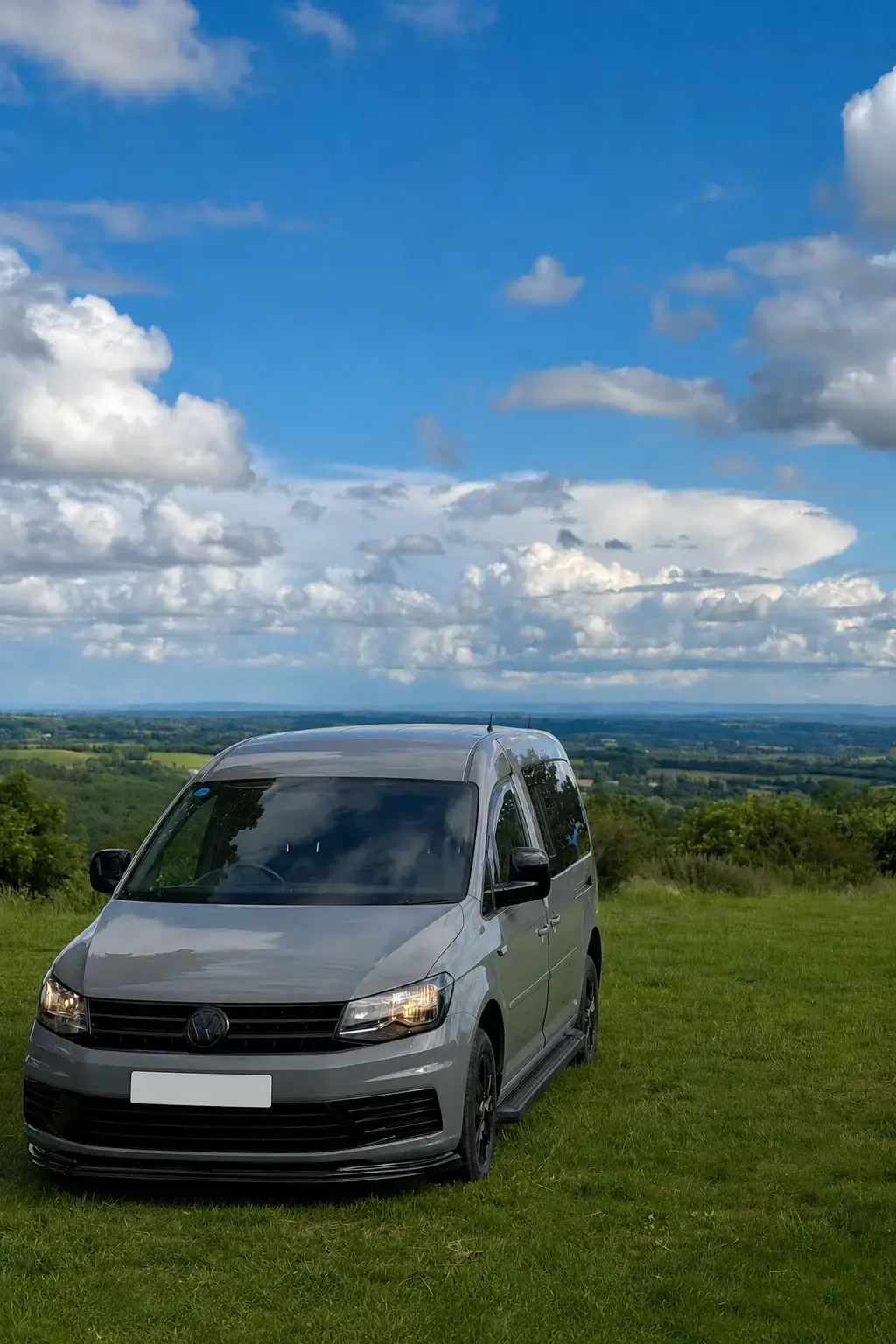 Sold grey Volkswagen camper photographed from the front with its registration concealed for privacy